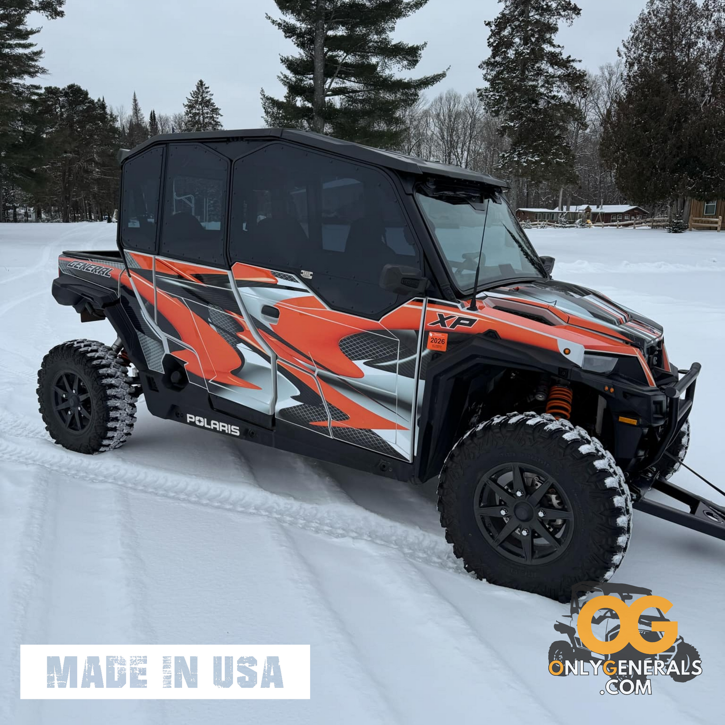 A multi-colored orange black and white Polaris General with the OG SideskinLITE doors.