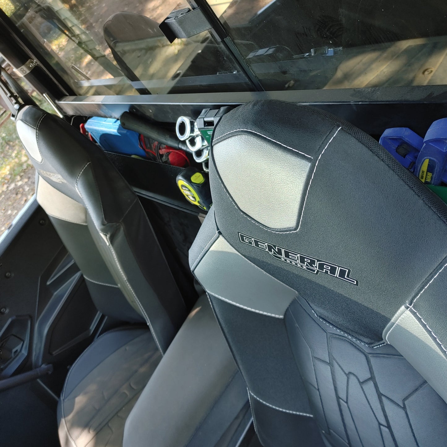 OnlyGenerals Polaris General 50 inch full length behind seat storage tray full of tools with seats installed.