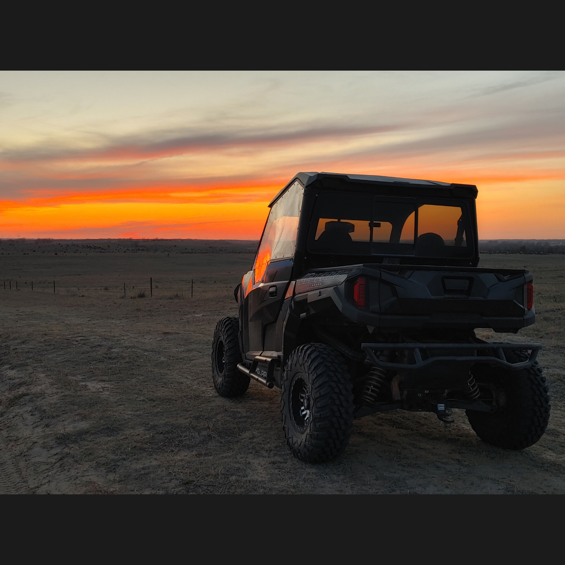 A beautiful sunset showcasing the reflective beauty of the Polaris General and the OnlyGenerals SideskinsLITE hard upper doors.