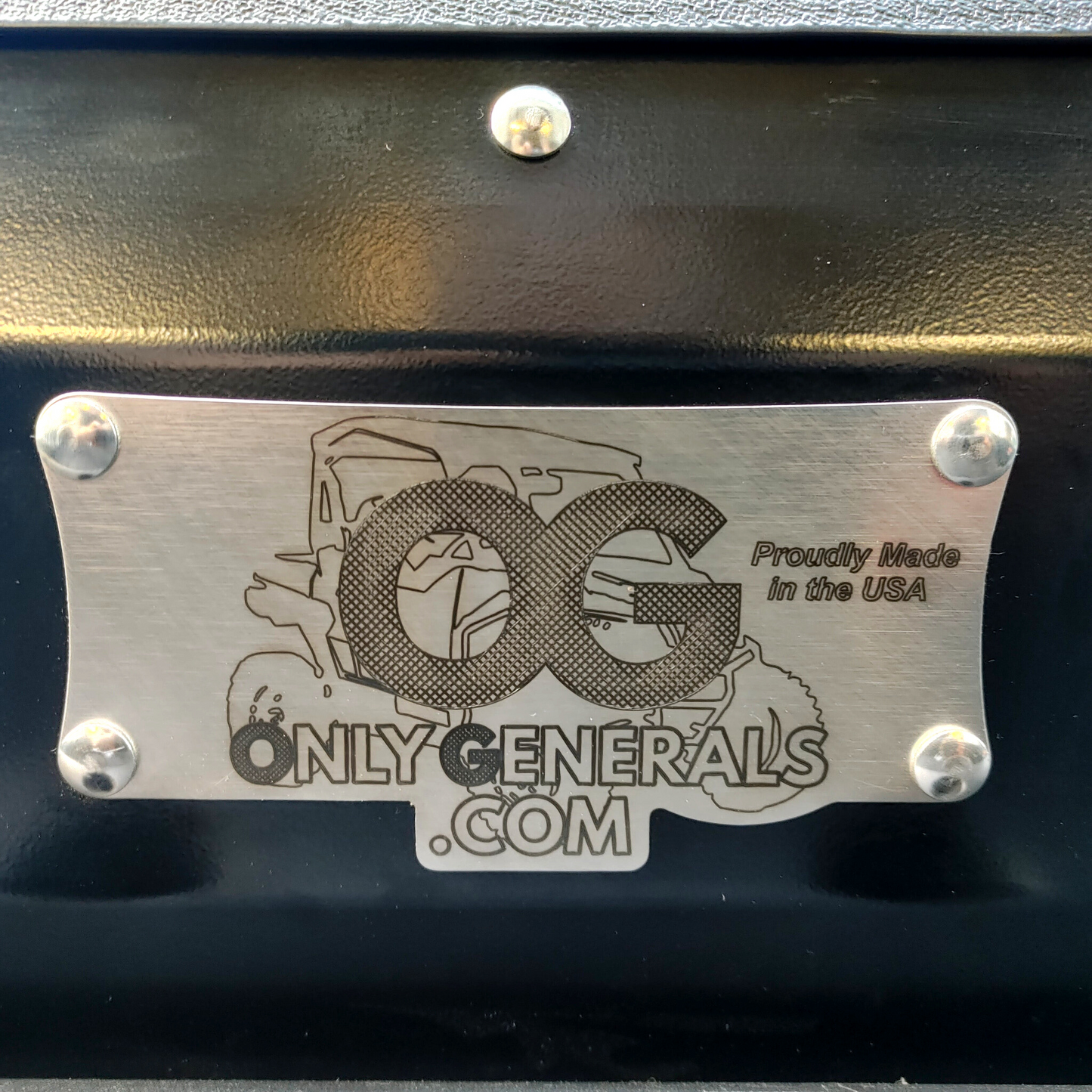 Very close up view of the OnlyGenerals etched stainless steel logo plate on the Polaris General lower filler panel